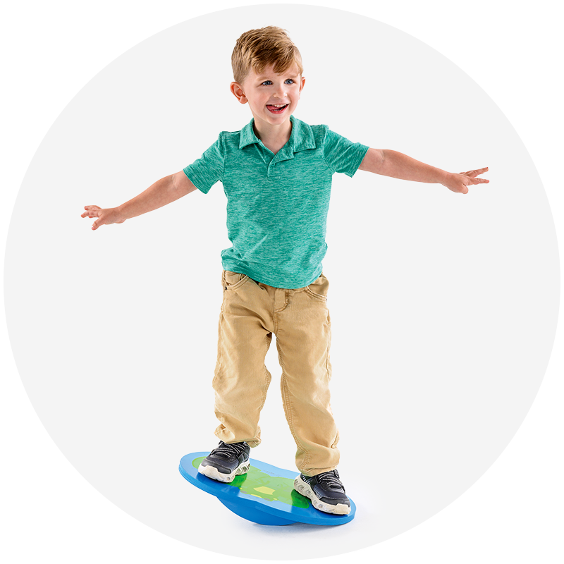 Two kids walking across colorful balance domes